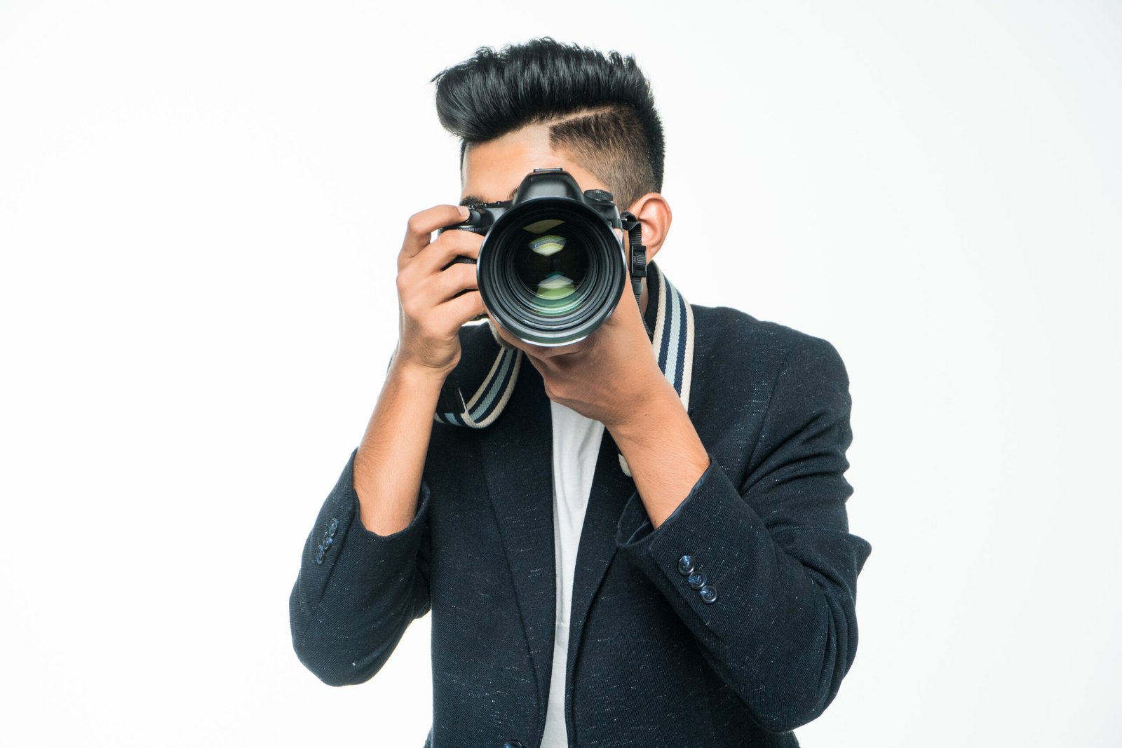 Young Asian man with camera isolated on white background. Photographer concept Young Asian man with camera isolated on white background.